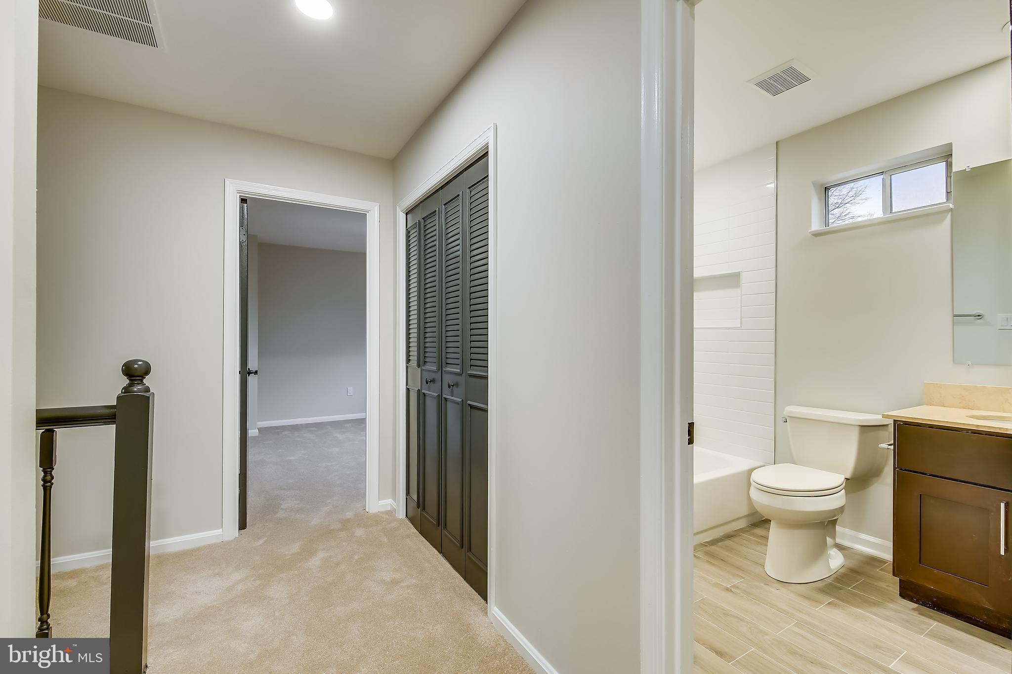 4238 Briars Road Olney, MD 20832 - Photo 27 of 44 a view of a bathroom with a toilet sink and a mirror