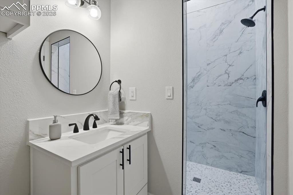 15755 Fool's Gold Lane Colorado Springs, CO 80921 - Photo 30 of 50 a bathroom with a sink and a mirror