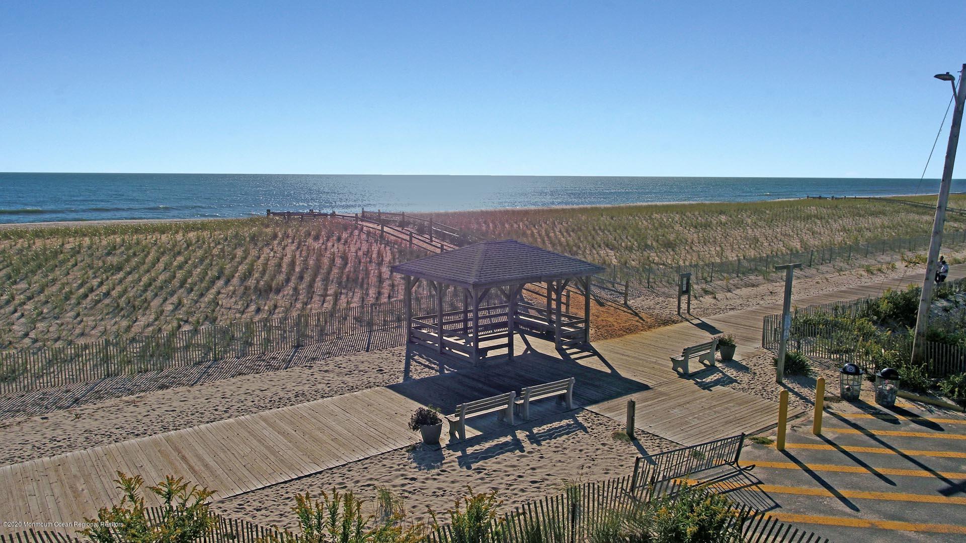 2106 Oceanfront Lavallette, NJ 08735 - Photo 8 of 17 a view of a terrace with wooden benches and a ocean view