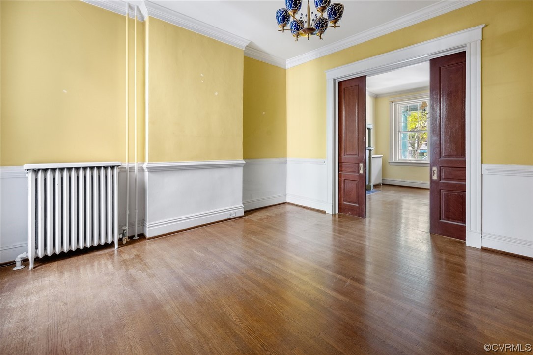 2018 Floyd Avenue Richmond, VA 23220 - Photo 14 of 36 an empty room with wooden floor and windows