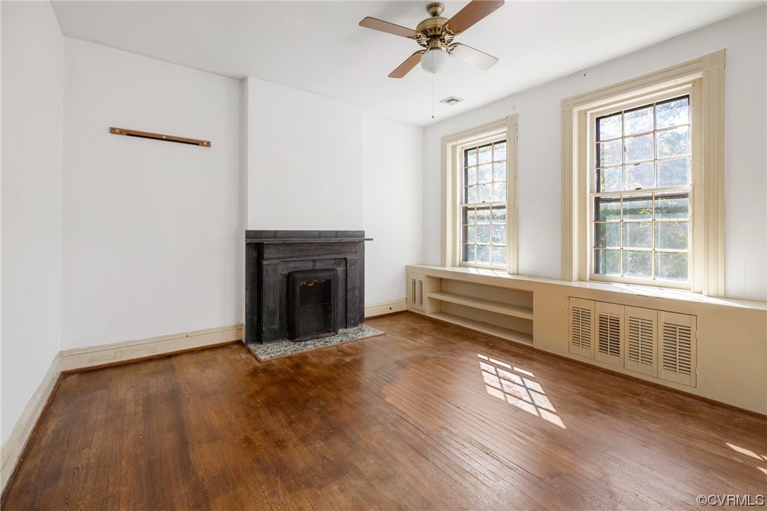 2018 Floyd Avenue Richmond, VA 23220 - Photo 24 of 36 wooden floor fireplace and windows in an empty room