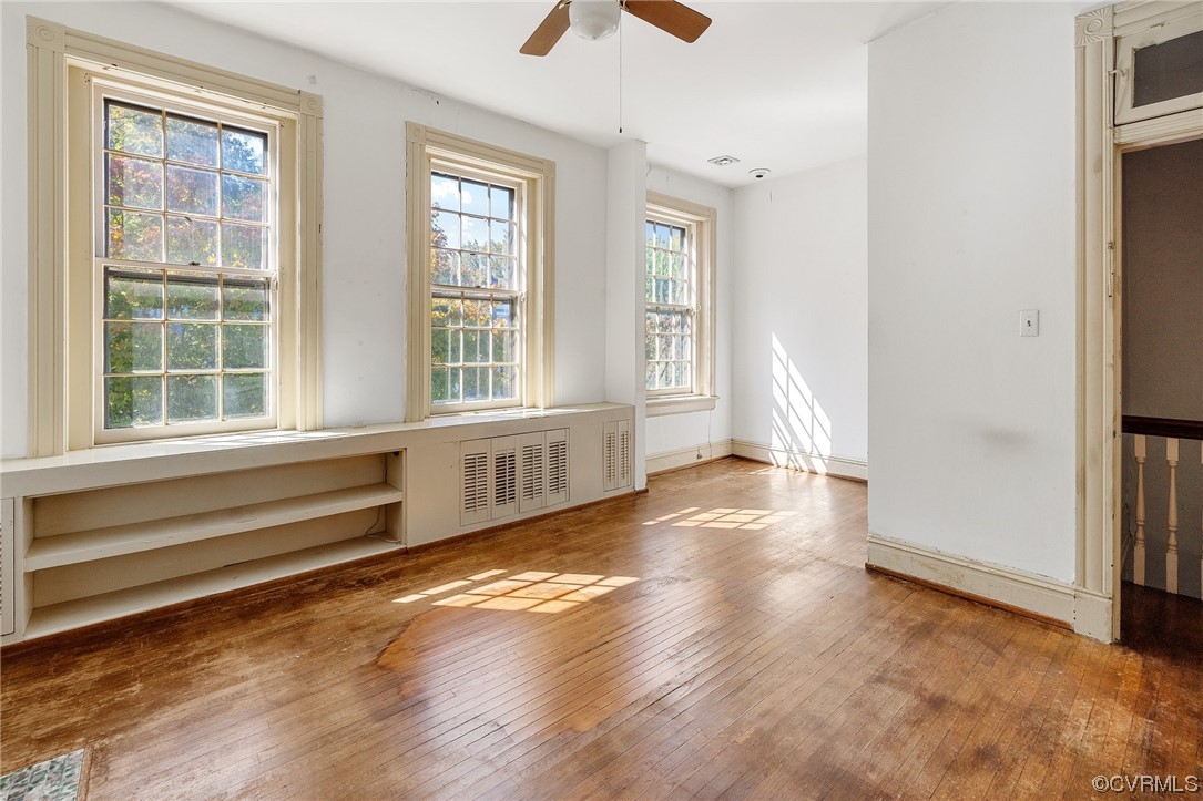 2018 Floyd Avenue Richmond, VA 23220 - Photo 25 of 36 an empty room with wooden floor and windows