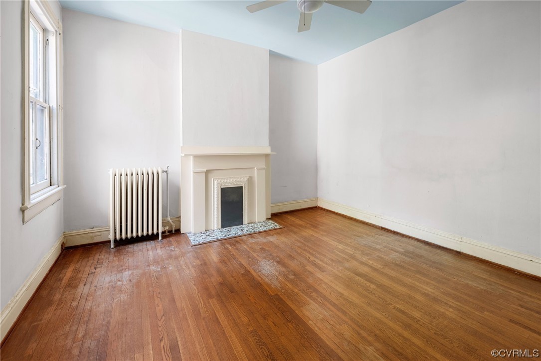 2018 Floyd Avenue Richmond, VA 23220 - Photo 26 of 36 an empty room with wooden floor and fireplace