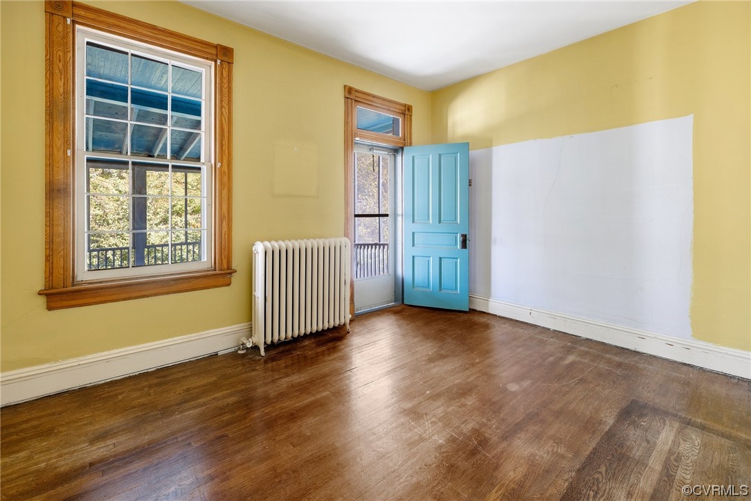 2018 Floyd Avenue Richmond, VA 23220 - Photo 30 of 36 an empty room with wooden floor and windows