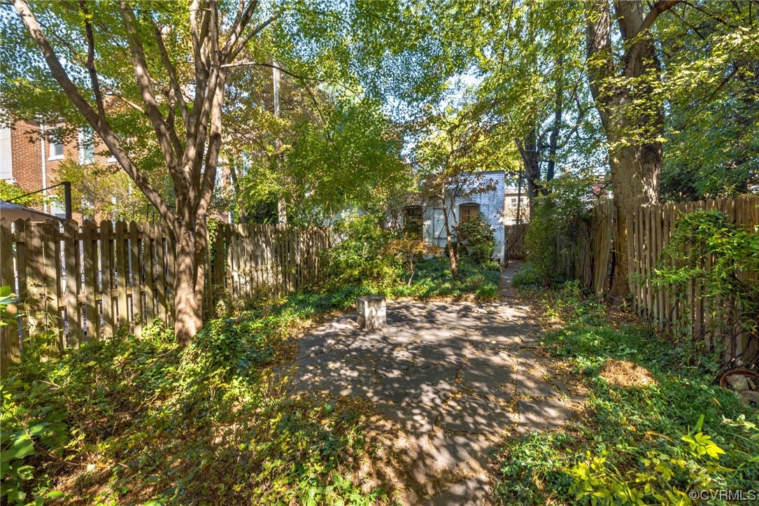 2018 Floyd Avenue Richmond, VA 23220 - Photo 35 of 36 a backyard of a house with lots of plants and large trees