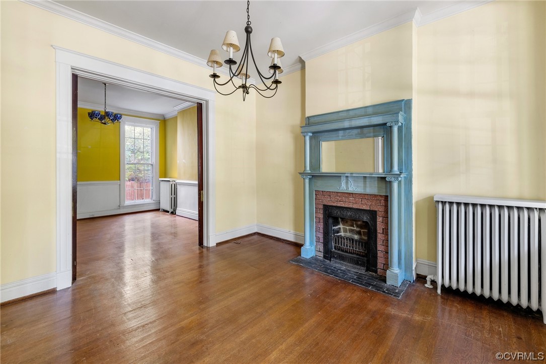2018 Floyd Avenue Richmond, VA 23220 - Photo 9 of 36 a view of a livingroom with a fireplace wooden floor and a fireplace