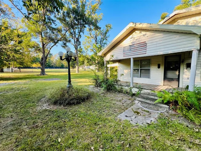 a front view of house with a garden