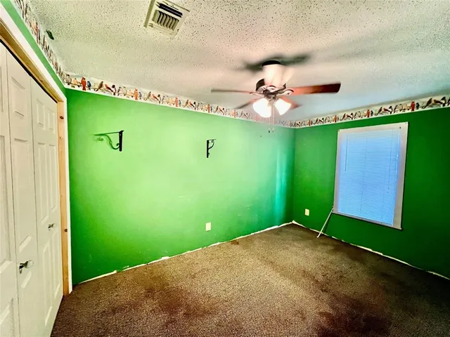 a view of a big room with potted plants to a ceiling window