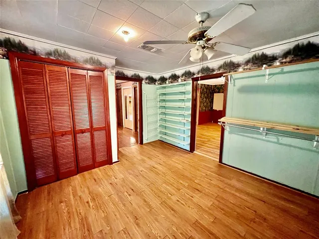 a view of a room with wooden floor