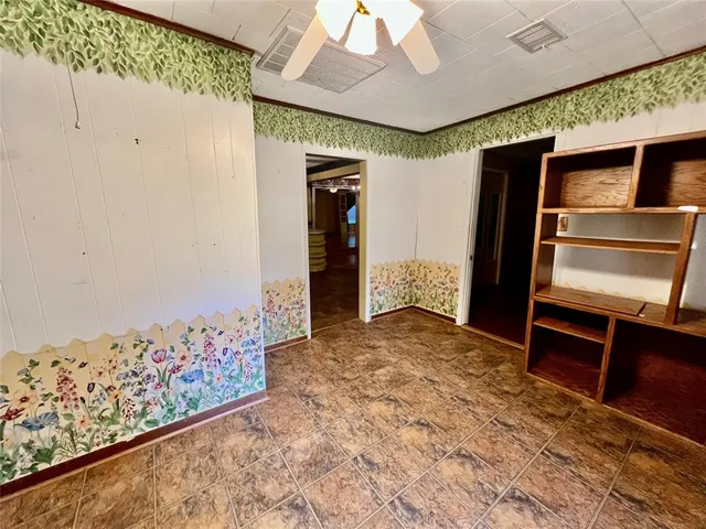 a view of room with window and ceiling fan