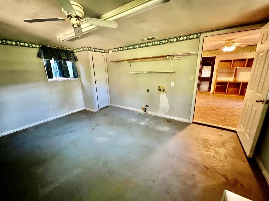 859 Farm To Market Road 2021 Lufkin, TX 75901 - Photo 16 of 20 a view of a big room with wooden floor and door