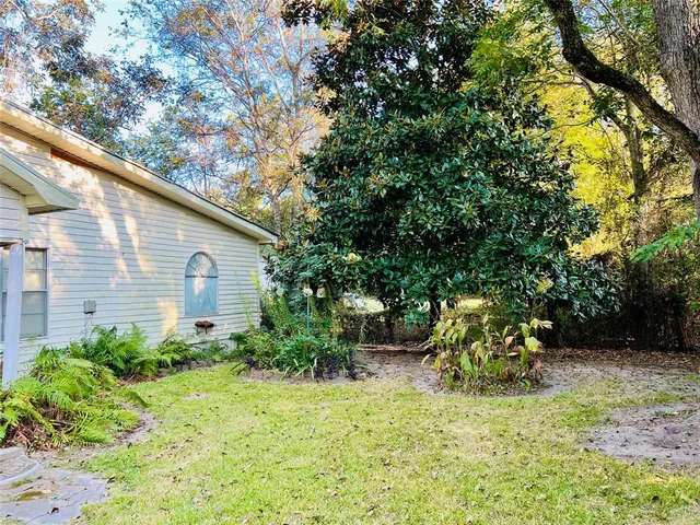 a backyard of a house with table and chairs