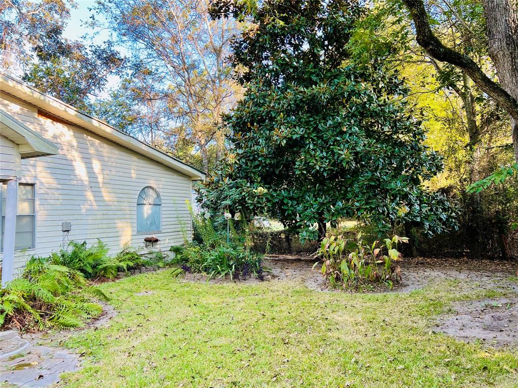 859 Farm To Market Road 2021 Lufkin, TX 75901 - Photo 18 of 20 a backyard of a house with table and chairs