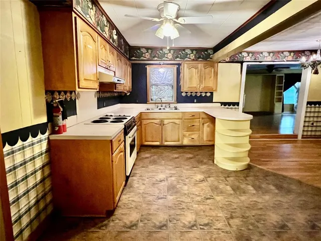 a kitchen with a stove a sink and a refrigerator