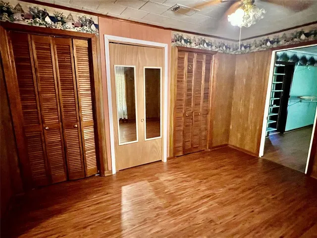 a view of a room with wooden floor and stairs