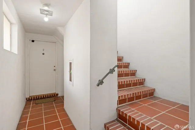 a view of room with stairs and wooden floor