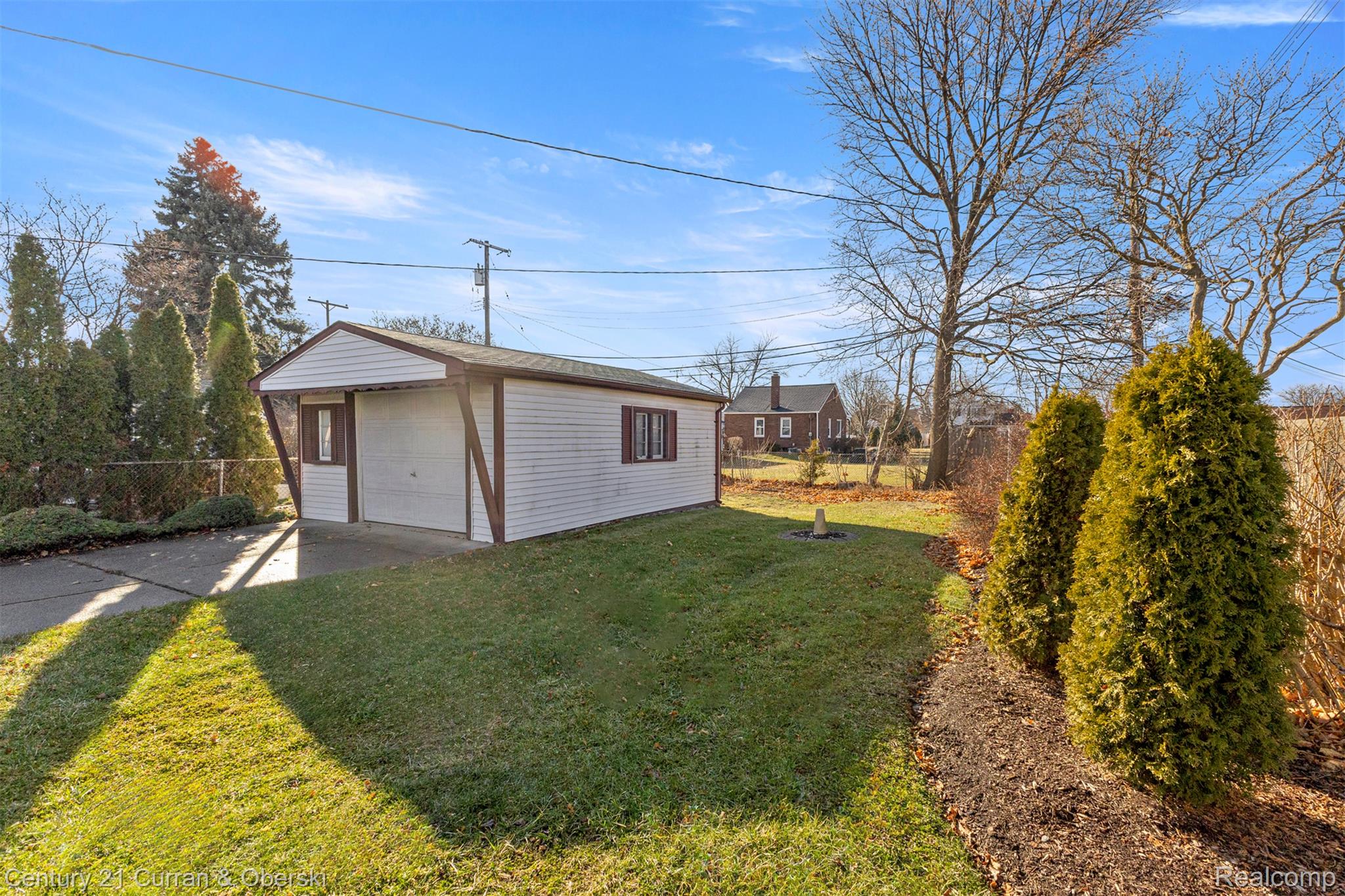 7120 Jackson Street Taylor, MI 48180 - Photo 23 of 24 View of yard with an outbuilding, a detached garage, and concrete driveway