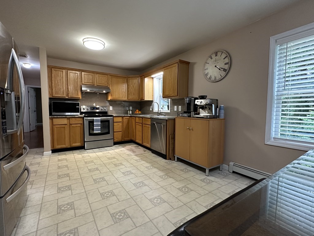 210 Pine Hill Road Russell, MA 01071 - Photo 12 of 29 a kitchen with stainless steel appliances granite countertop a stove top oven a sink a counter space and cabinets