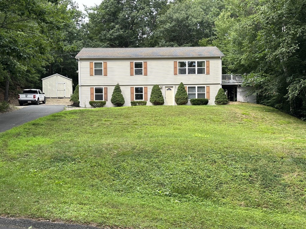 210 Pine Hill Road Russell, MA 01071 - Photo 2 of 29 a front view of a house with a garden
