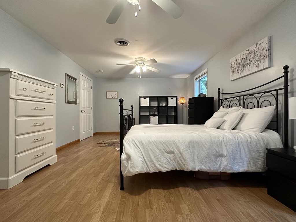 210 Pine Hill Road Russell, MA 01071 - Photo 25 of 29 a spacious bedroom with a bed and a ceiling fan
