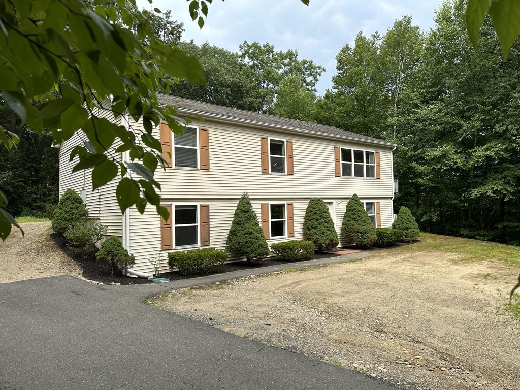 210 Pine Hill Road Russell, MA 01071 - Photo 3 of 29 a front view of a house with a yard and garage