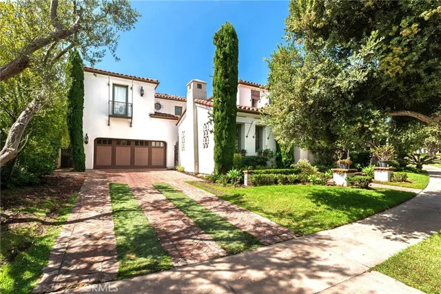 a front view of a house with a garden and yard