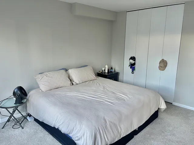 a bedroom with a bed and a table