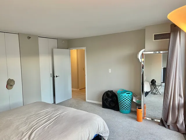 a bedroom with a bed and a shower