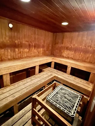 a living room with furniture a table and kitchen view