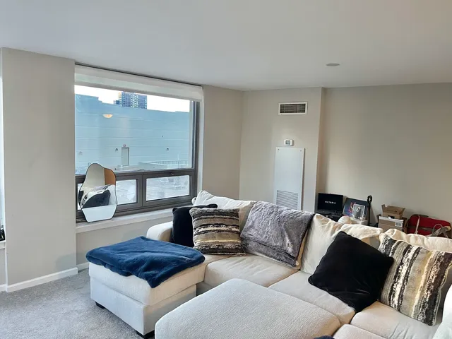 a living room with furniture and a mirror