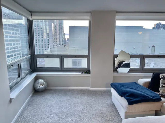 a living room with a couch and a large window