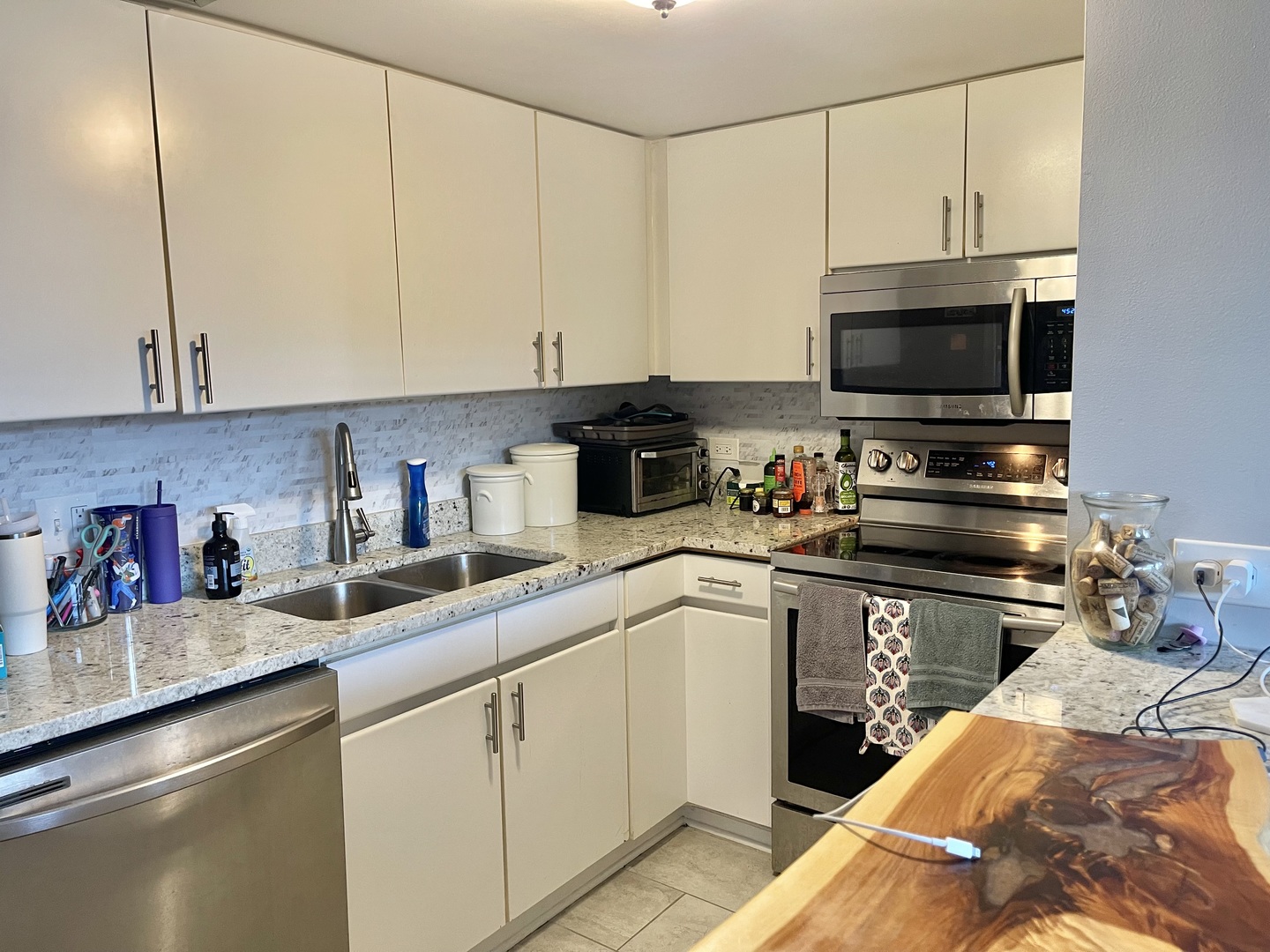 440 North Wabash Avenue, Unit 1903 Chicago, IL 60611 - Photo 9 of 34 a kitchen with a sink and white cabinets