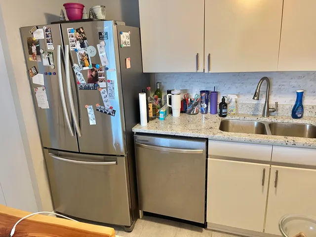 a kitchen with refrigerator and cabinets