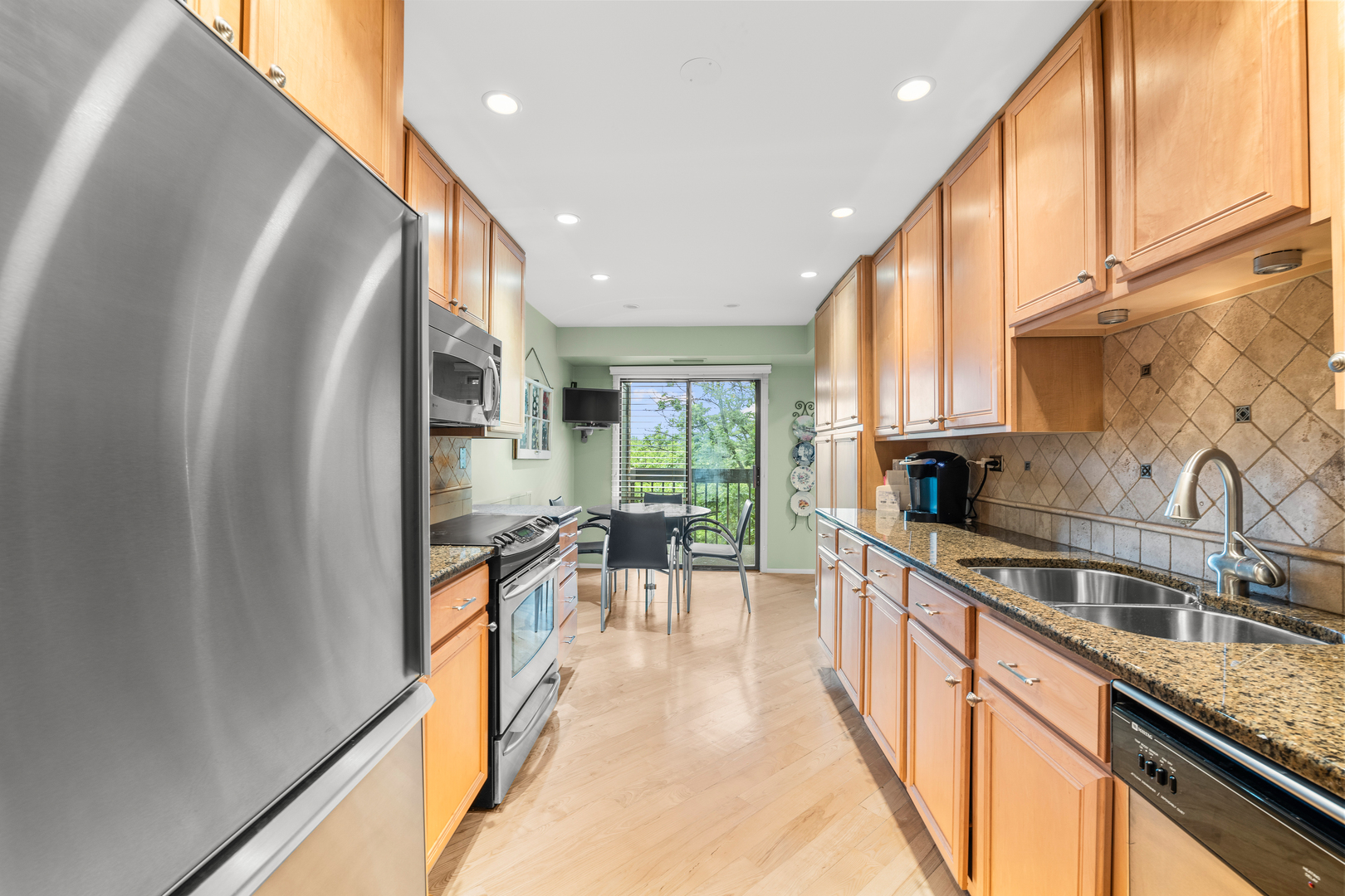 1771 Mission Hills Road, Unit 412 Northbrook, IL 60062 - Photo 10 of 21 a kitchen with granite countertop a sink a counter top space and stainless steel appliances