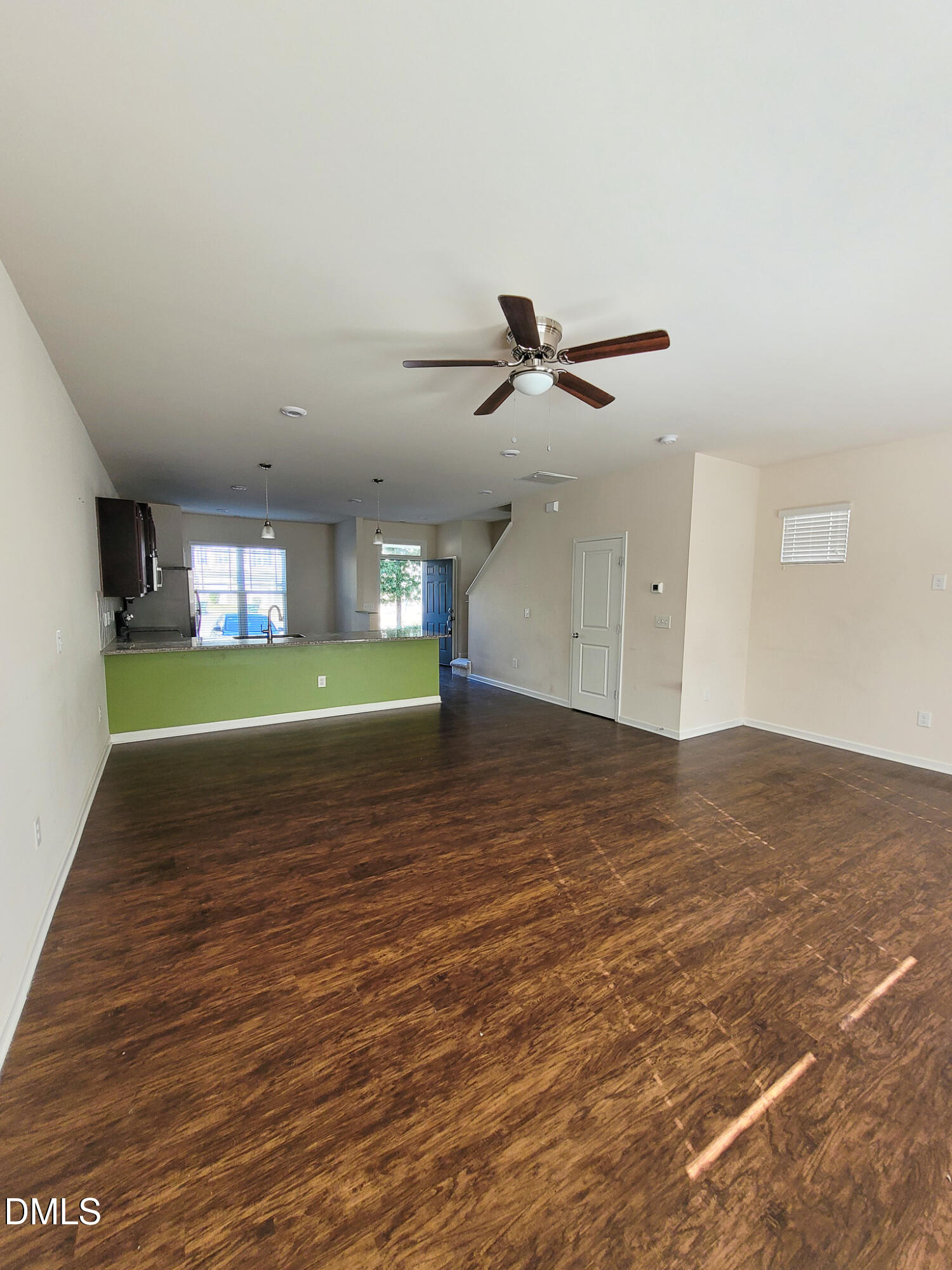 8951 Commons Townes Drive Raleigh, NC 27616 - Photo 15 of 40 a view of a livingroom with a hardwood floor and a ceiling fan