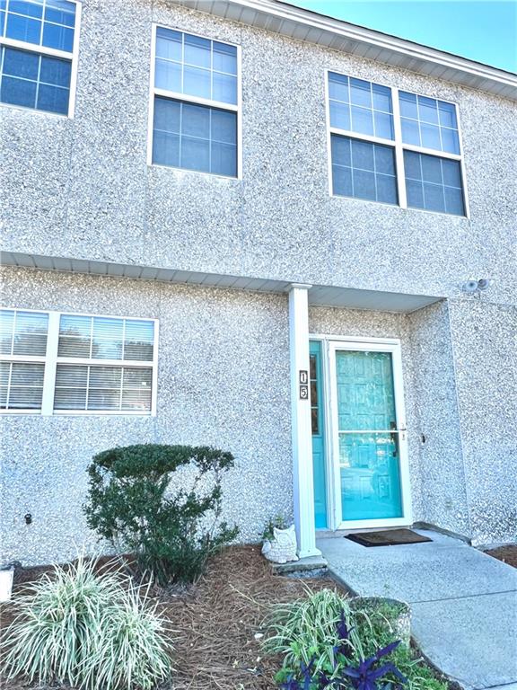 1000 Mallery St Extension, Unit C15 St. Simons, GA 31522 - Photo 1 of 1 a front view of a house with a garden