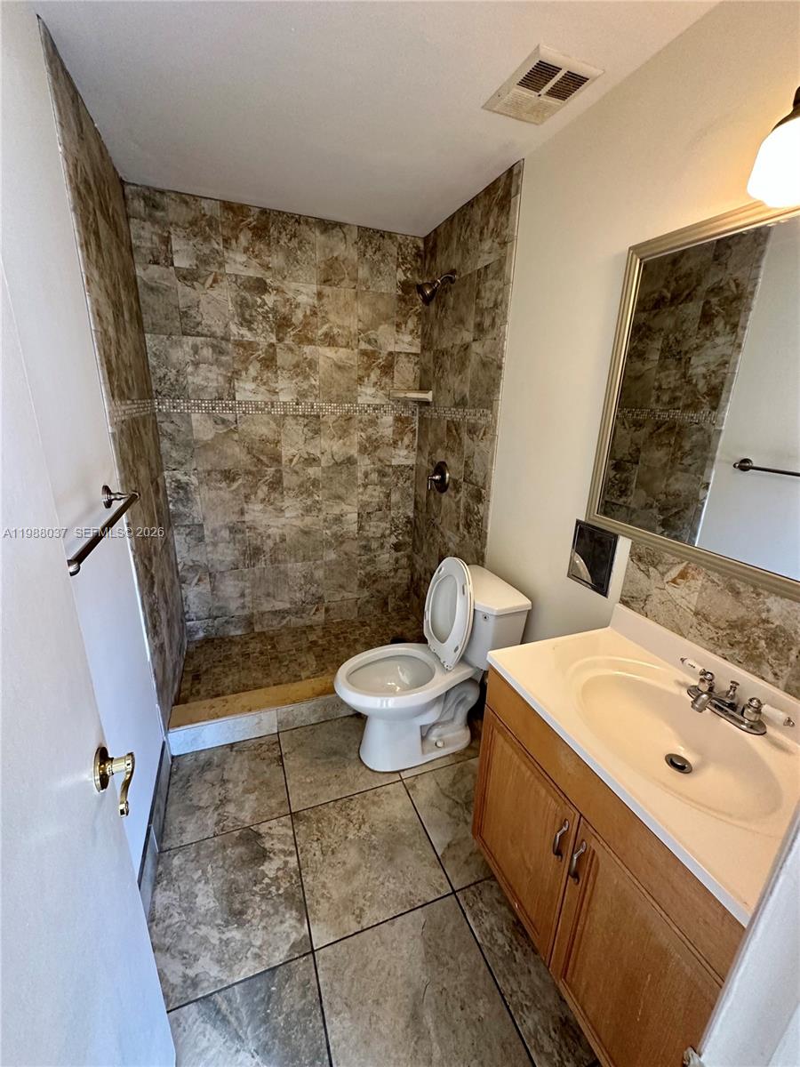 13705 Southwest 84th Street, Unit F Miami, FL 33143 - Photo 11 of 12 a bathroom with a sink toilet and shower
