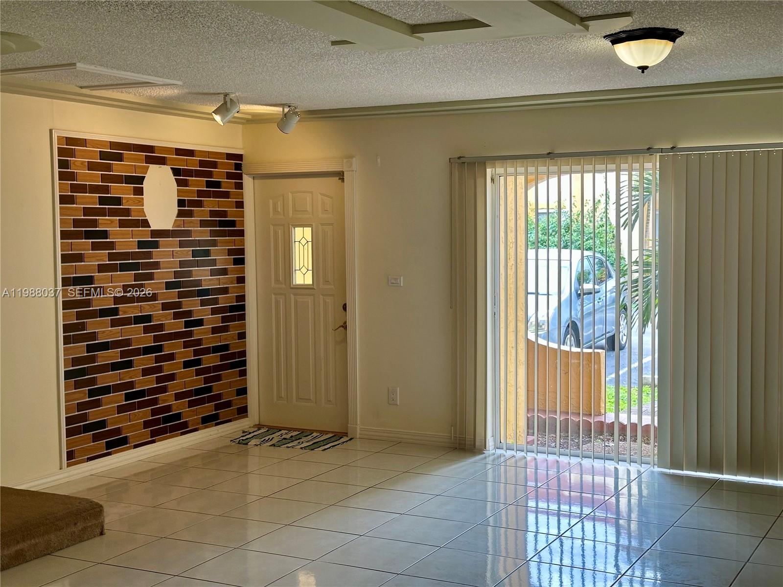 13705 Southwest 84th Street, Unit F Miami, FL 33143 - Photo 3 of 12 a view of an empty room and window