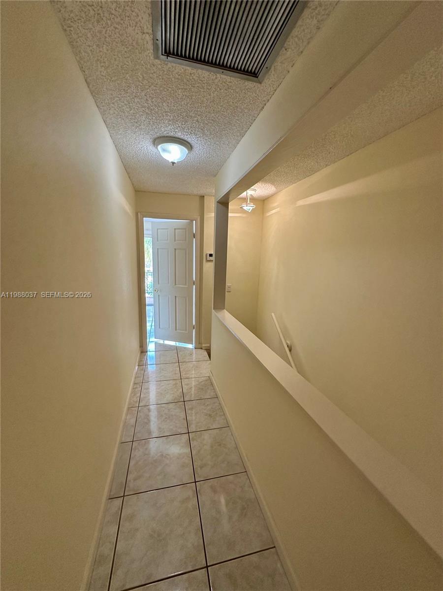 13705 Southwest 84th Street, Unit F Miami, FL 33143 - Photo 6 of 12 a view of hallway with a large window
