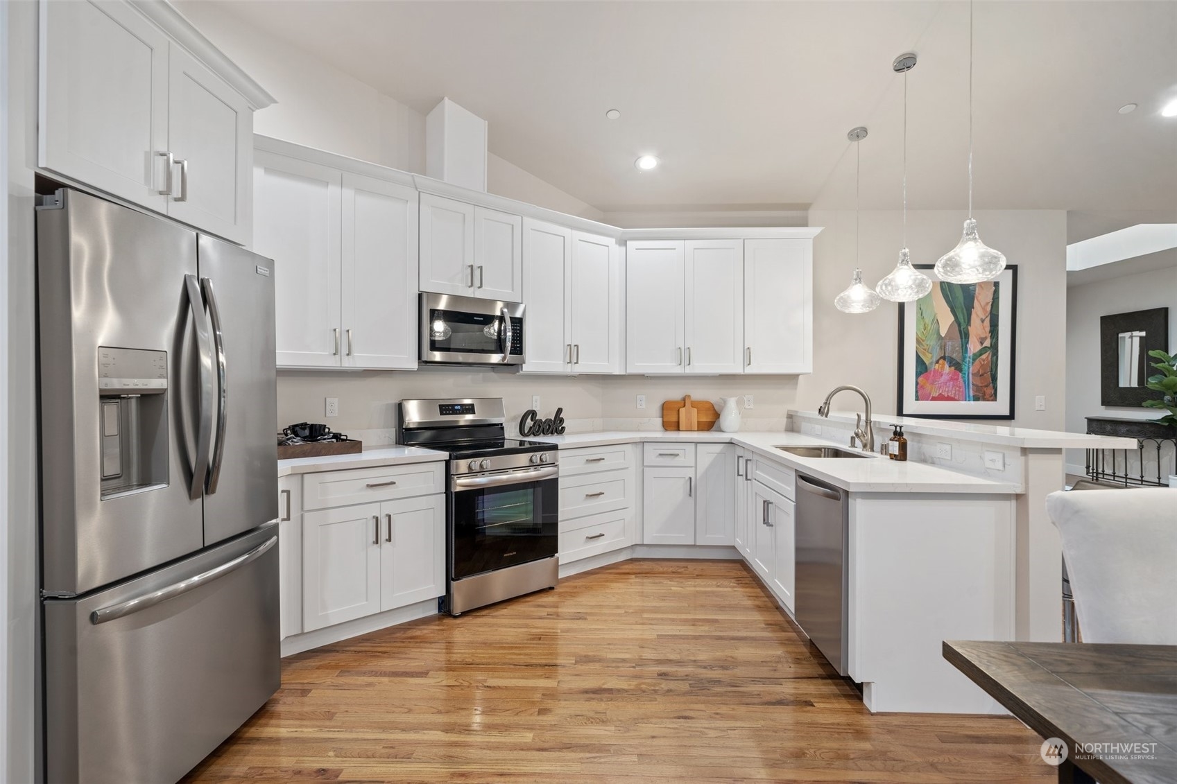 3336 McCary Road Southwest Port Orchard, WA 98367 - Photo 6 of 23 a kitchen with white cabinets and stainless steel appliances