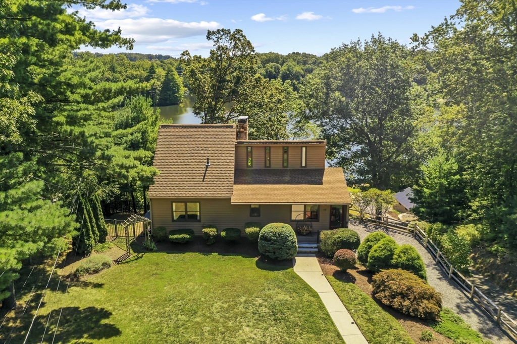 an aerial view of a house with yard swimming pool and outdoor seating