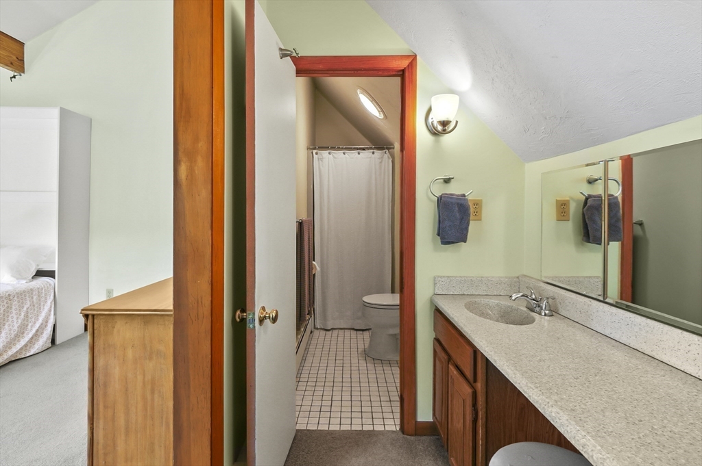 19 Sprague Road Clinton, MA 01510 - Photo 29 of 40 a bathroom with a granite countertop sink and a mirror