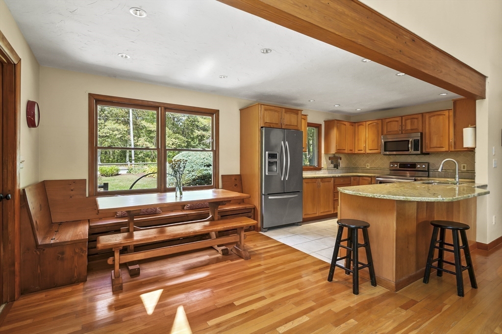 19 Sprague Road Clinton, MA 01510 - Photo 10 of 40 a living room with furniture a kitchen view and large windows