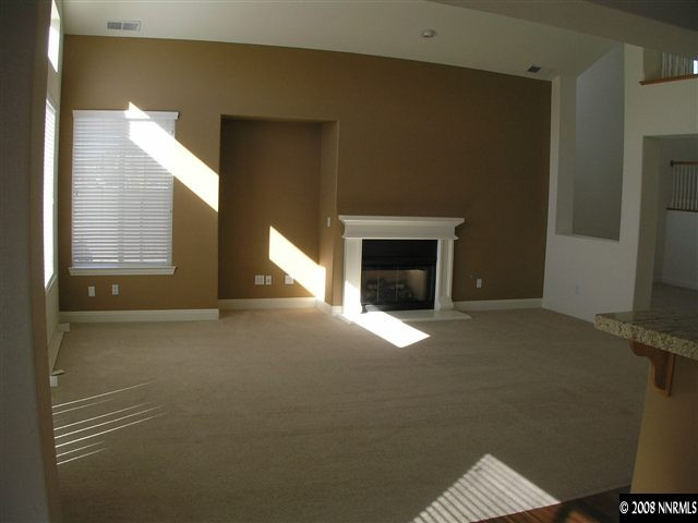 610 Equine Court Reno, NV 89521 - Photo 3 of 9 a view of empty room with a fireplace