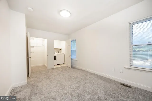 an empty room with windows and entrance