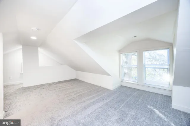 an empty room with windows and entrance