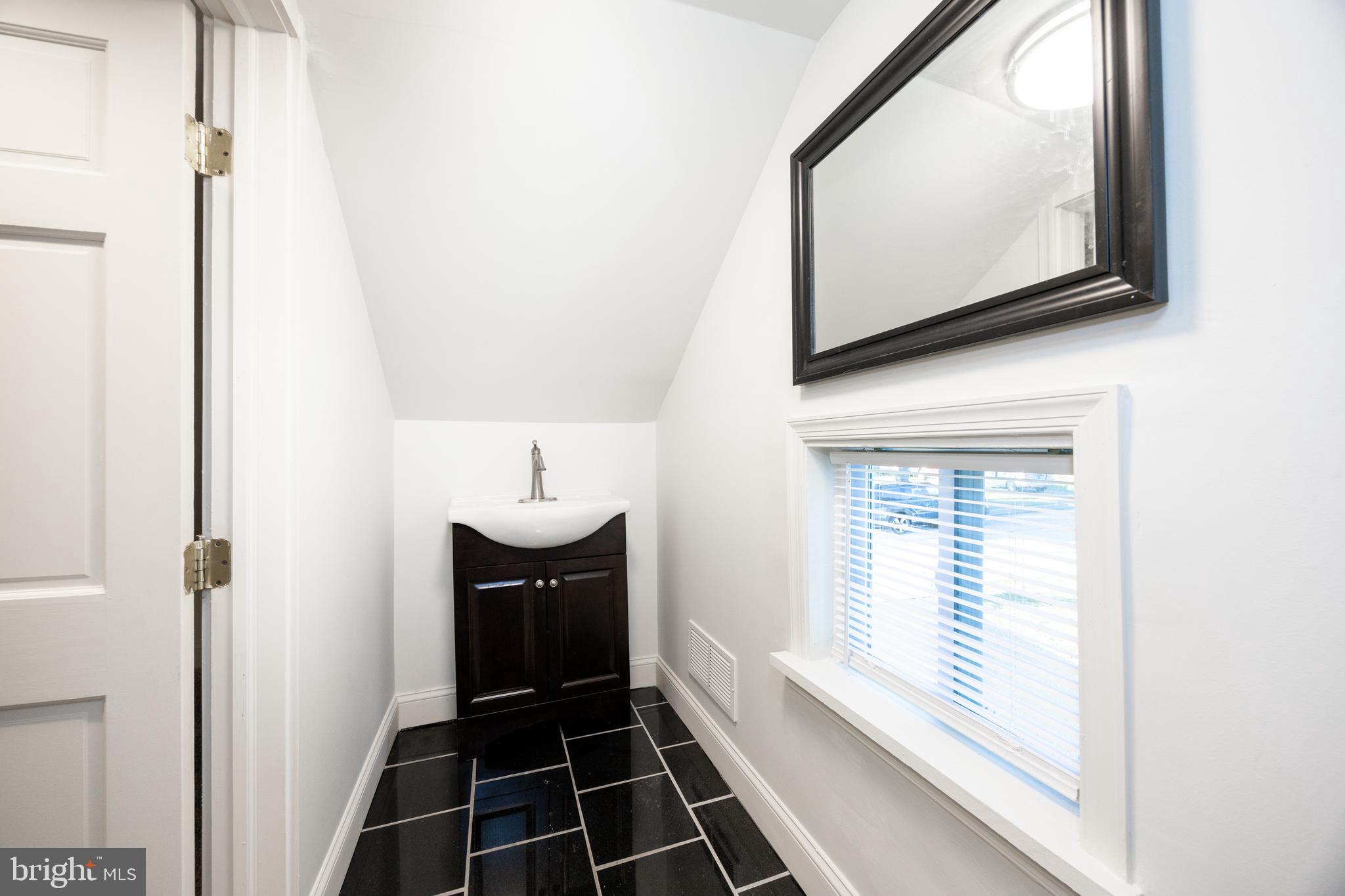 103 Valley View Road Phoenixville, PA 19460 - Photo 23 of 38 a bathroom with a sink and a mirror