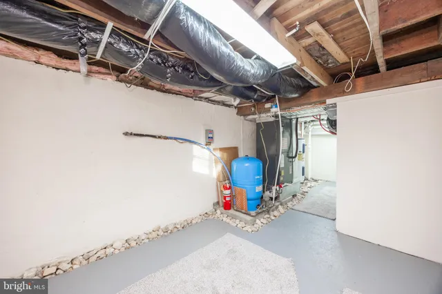 a backyard of a house with barbeque oven table and chairs