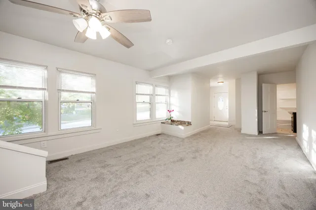 a view of an empty room with a window