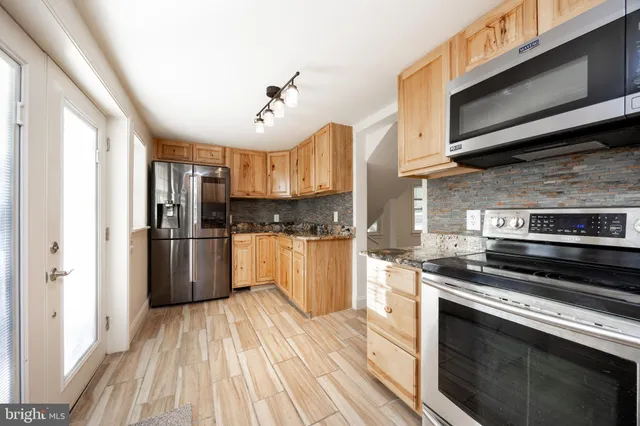 a kitchen with a stove a sink and a microwave